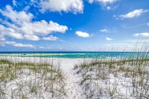 A beach with clear skies and ocean waves.