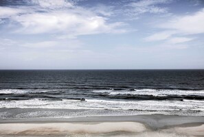 A beach with waves and a clear sky. - Waterfront Daytona Beach Shores Condo w/ Amenities (Daytona Beach Shores)