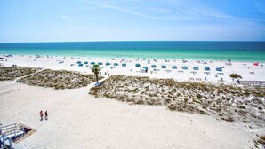 A beach with tents and people.