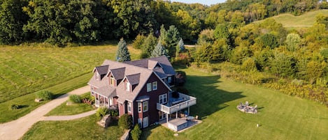 A large, two-story house with a spacious front yard and a driveway leading to the entrance.
