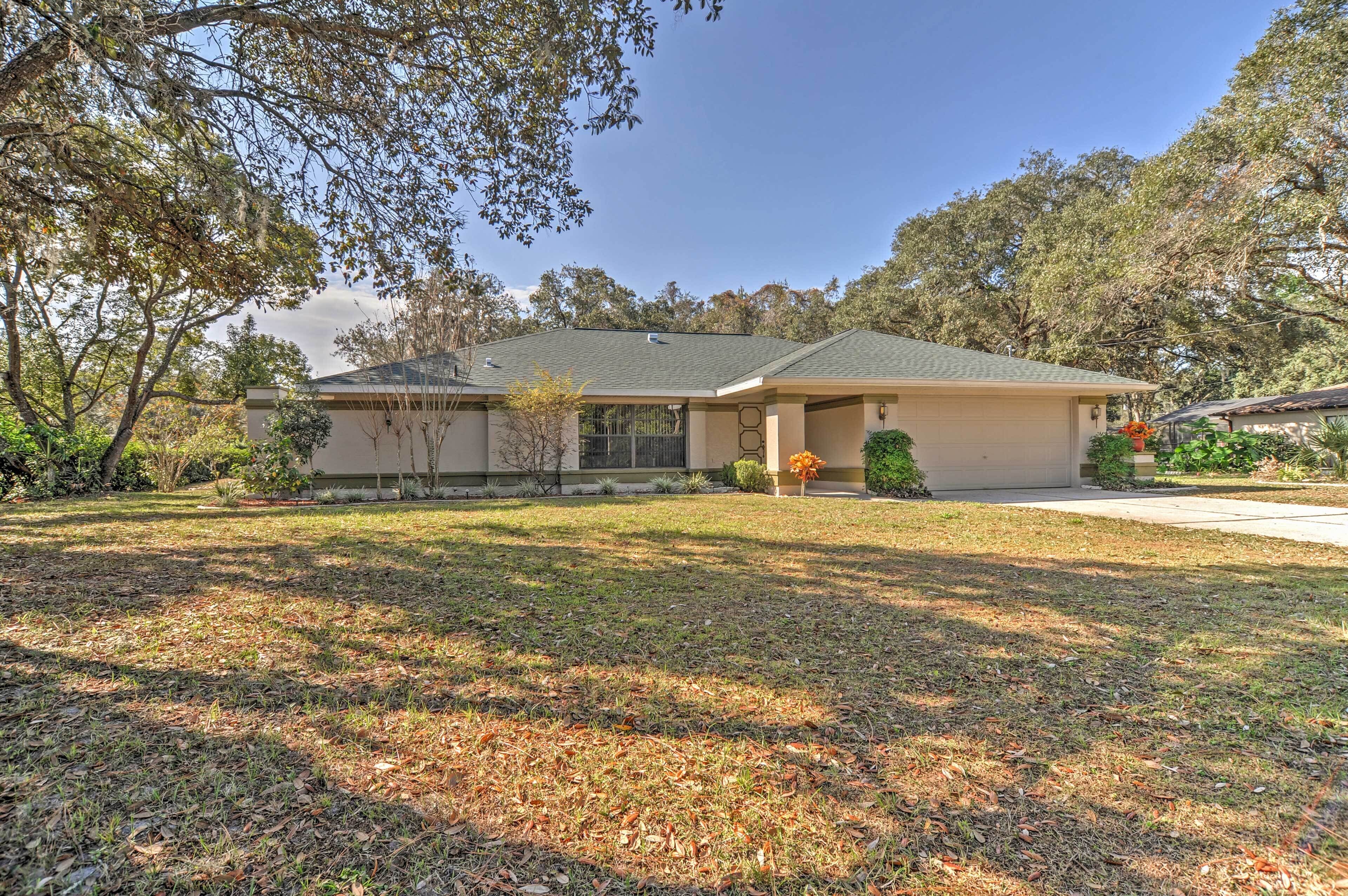A single-story house with a front porch, a covered driveway, and a well-maintained lawn.