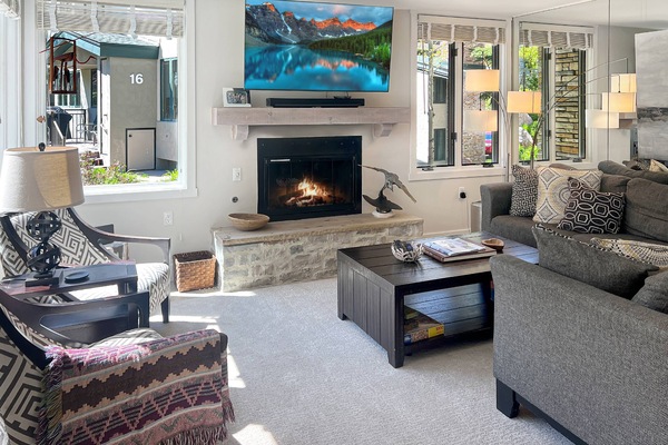 The cozy living room with tv and a gas fireplace is the perfect place to gather