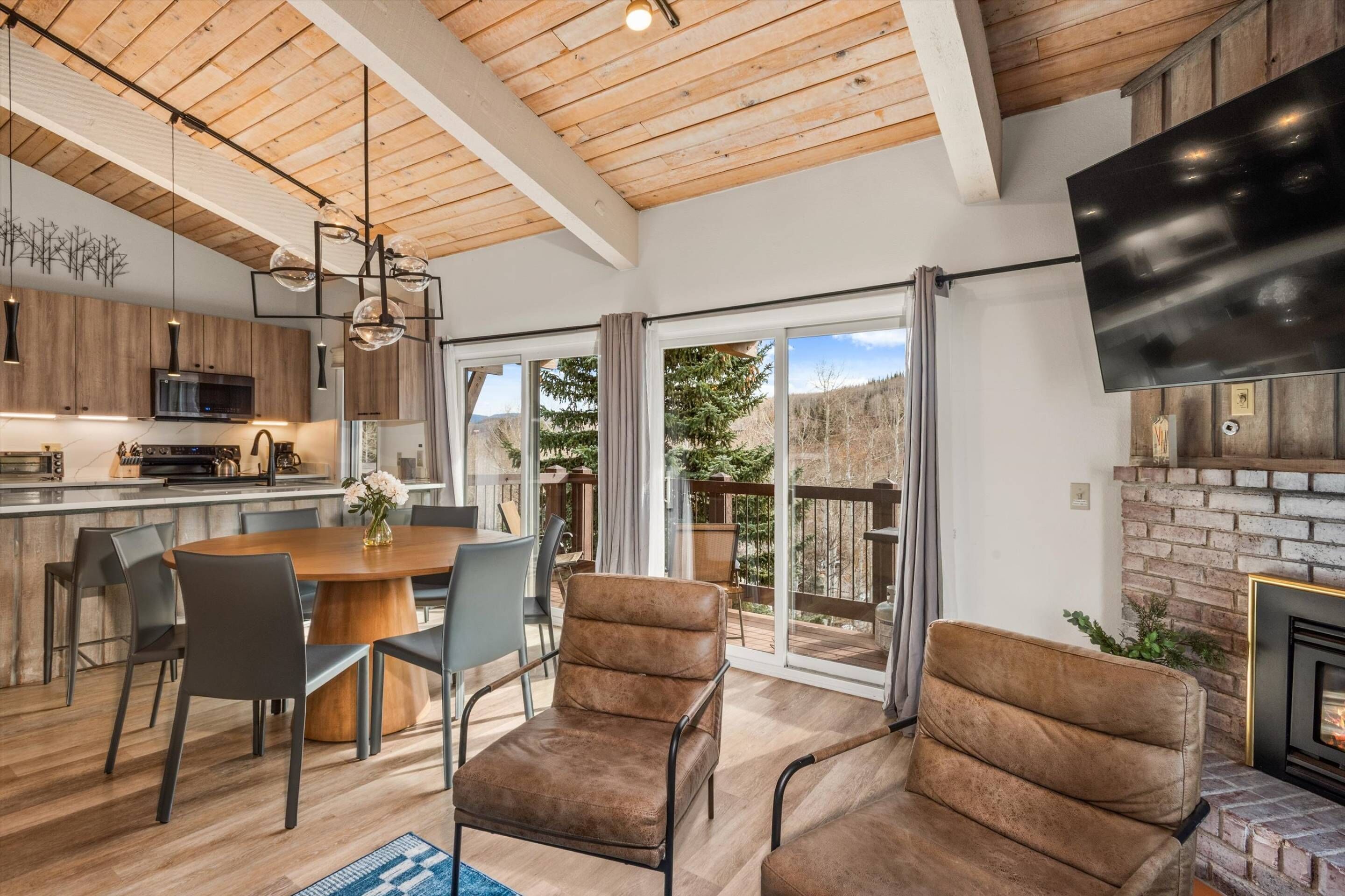 Enjoy the amazing light and views from the windows and the cozy living room with a fireplace, new smart tv and dining table for 6