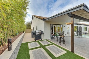 A patio with a grill, outdoor seating, and a swimming pool. - Desert Oasis Ranch-Style Mesa Home, Hiking/Tubing (Mesa)