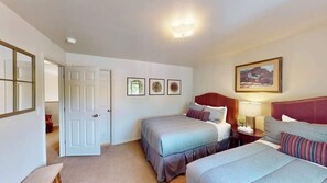 A hotel room with a bed, bedside table, lamp, and a painting on the wall. - Henning's Escape - 3328 (Moab)
