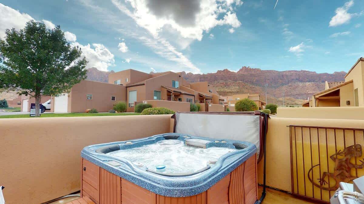 A hot tub on a balcony with a mountain view.