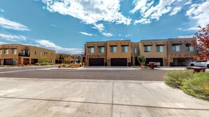 A residential area with modern two-story houses, paved driveways, and landscaped gardens. - Entrada at Moab - 668, Wolf Den (Moab)