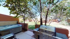 An outdoor patio with a hot tub, grill, and seating area. - The Hacienda - 3333, Private Hot Tub (Moab)
