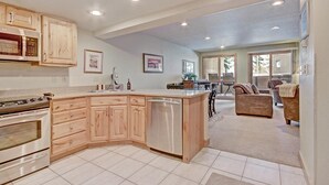 A modern kitchen with wooden cabinets, a built-in oven, and a dishwasher. - Beautiful Ski in/out Condo, Great Location! CM244 (Copper Mountain)