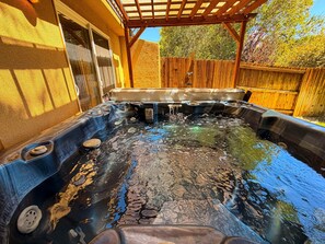A hot tub with a wooden deck and a wooden fence in the background. - Arches West - 393, Townhome In Moab's most request (Moab)