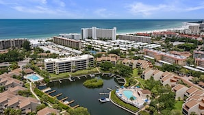 A resort with multiple buildings, a marina, and a beach. - Spacious vacation rental condo with lagoon views, beach access, and pool (Siesta Key)