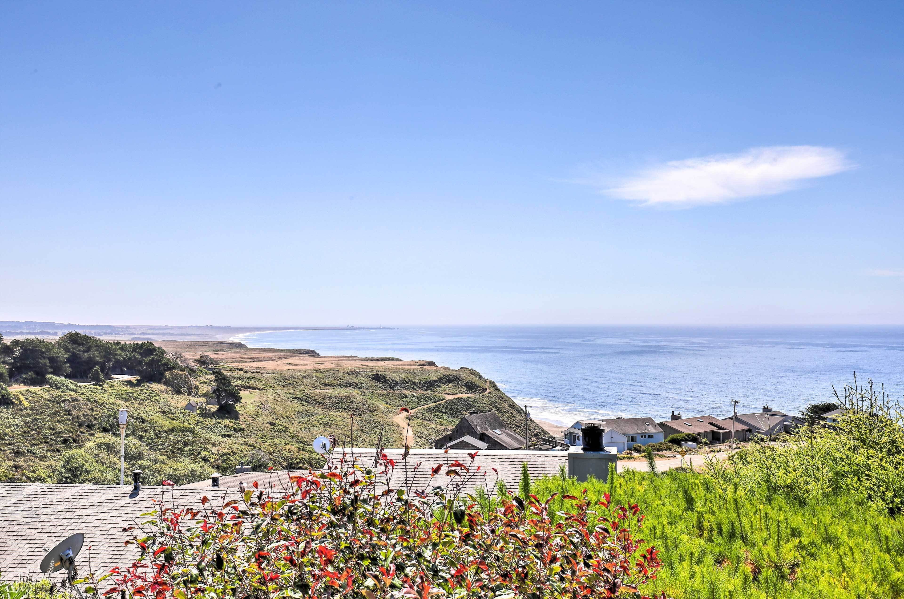 A coastal view with houses and a clear sky.