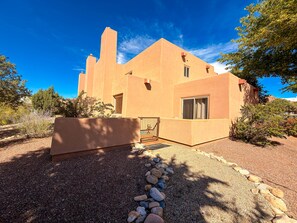 A stucco building with a flat roof, a large front door, and a window. - Sunset View - 3234 (Moab)