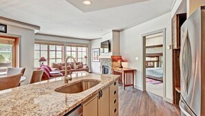 A spacious kitchen with granite countertops, a double sink, and a large refrigerator. - Perfect Passage To Copper Mountain with available hot tub! PP327 (Copper Mountain)