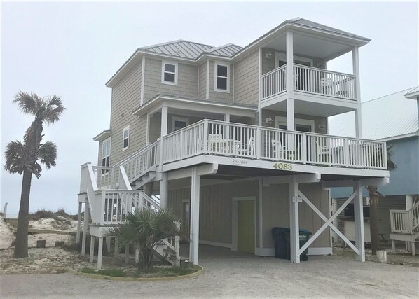 A multi-story beach house with a balcony, a covered porch, and a sandy beach area. - Beach Front, dog friendly, 20 steps to Beach! (Cape San Blas)