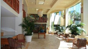 A spacious lobby with a large mural, comfortable seating, and potted plants. - Time to Spoil Yourself!  Deluxe Ocean Front and Steps to N. Kaanapali Beach ~ (Lahaina)