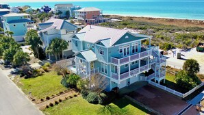 Une vaste propriété en bord de mer, composée de plusieurs étages, dotée d’un balcon imposant et offrant une vue sur l’océan.