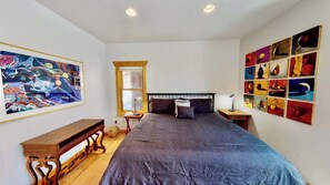 A bedroom with a large bed, a wooden bench, a window, and a wall with multiple framed pictures. - Rim View Retreat - 14, Luxurious Stand-Alone 3 Be (Moab)