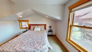 A bedroom with a large bed, a window, a nightstand, and a lamp. - Rim View Retreat - 14, Luxurious Stand-Alone 3 Be (Moab)