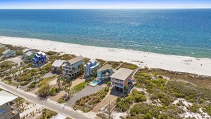 A beachfront property with multiple buildings, a swimming pool, and a road leading to the beach. - 4 Bdrm Gulf Front Home w/Private Pool (Cape San Blas)