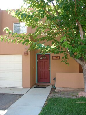 A residential house with a red door, a mailbox, and a number sign above the door. - River Days - 3326, Enjoy La Sal Mountain Views (Moab)