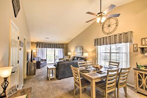 Enjoy a comfortable stay in this spacious room with a dining area, sofa, and large window offering a view of the outdoors.
