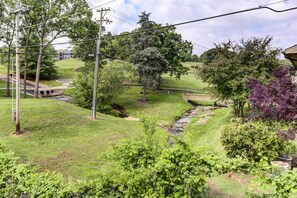 Surrounded by lush trees and a serene stream, this property offers a peaceful retreat.