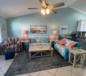 A living room with a ceiling fan, two couches, a coffee table, and a rug. - 4bdrm Townhome on N CSB (Cape San Blas)