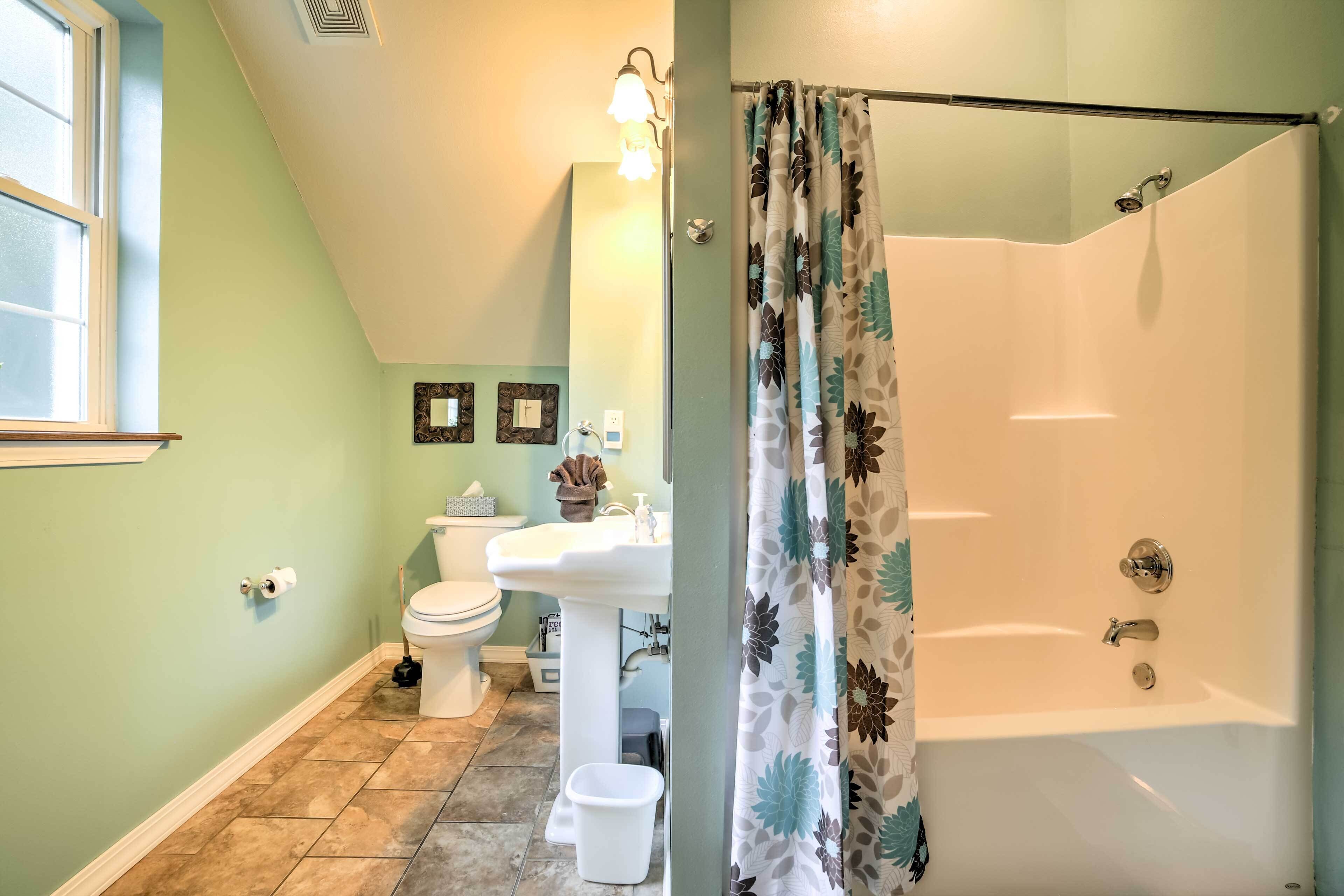 A bathroom with a toilet, sink, and bathtub.