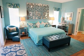 A bedroom with a bed, two nightstands, a chair, a dresser, and a mirror. - Beach Front Fun & Relaxation (Port St Joe)