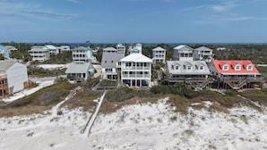 A coastal residential area with multiple beachfront houses featuring balconies and decks. - Casual Beach Front with New Owners: Lots of updates! (Cape San Blas)