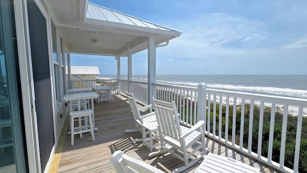 A covered deck with white furniture and a view of the ocean. - Casual Beach Front with New Owners: Lots of updates! (Cape San Blas)