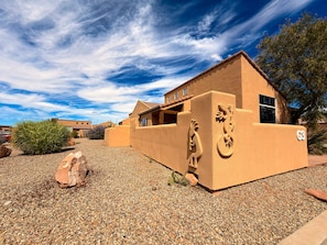 A desert-style building with a flat roof, a large window, and a number 'G3' on the side.