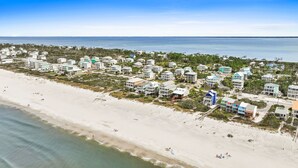 A coastal residential area with beachfront properties, including houses and condos, and a sandy beach. - 5 Bedroom Beachfront (Cape San Blas)