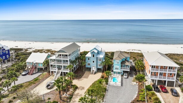 A beachfront property with multiple buildings, a swimming pool, and a beach view. - 5 Bedroom Beachfront (Cape San Blas)