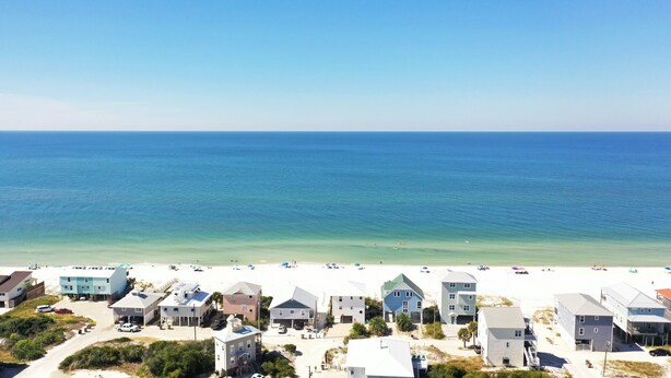 A coastal area with beach houses and a sandy beach. - Pet Friendly Beach Front Home (Cape San Blas)