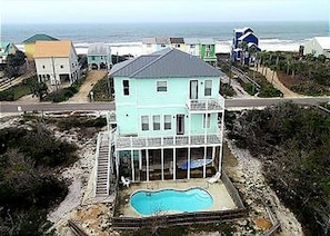 A two-story house with a balcony and a swimming pool. - 1st Tier Home with Private Pool! (Cape San Blas)