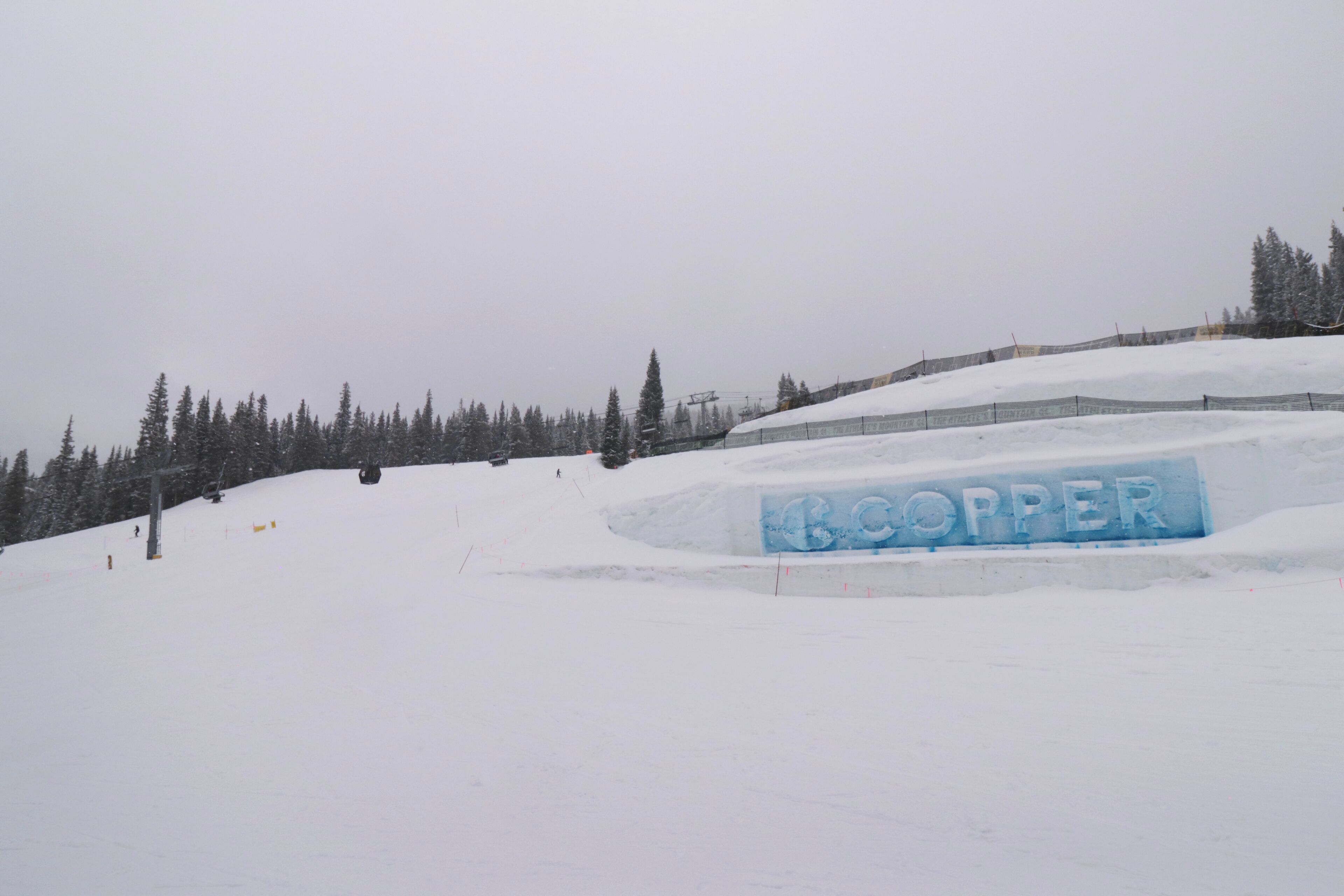 A snow-covered ski slope with a sign that reads "BOOPPER".