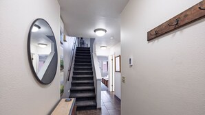 A hallway with a wooden bench, a mirror, and a staircase leading to another room. - Pitchfork 456: Town of Jackson- Renovated- Walk to Town Square (Jackson)