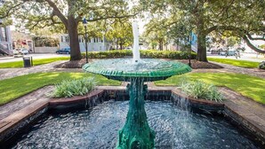 A fountain with a central spout and water cascading down into a circular basin. - First Floor Condo w/ Large Living Area in Historic Dist. by Lucky Savannah (Savannah)