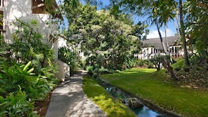 Stroll through the serene garden to a classic building with a comfortable and inviting atmosphere.