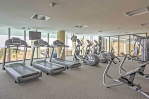 A gym with treadmills, elliptical machines, and weight equipment.