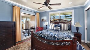 A bedroom with a bed, dresser, ceiling fan, window with blinds, and a view of the outdoors. - Nalo Studio A By Parrish Kauai - local vibe & walk to Poipu Beach (Koloa)