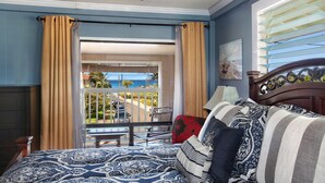 A hotel room with a balcony overlooking a beach and ocean. - Nalo Studio A By Parrish Kauai - local vibe & walk to Poipu Beach (Koloa)