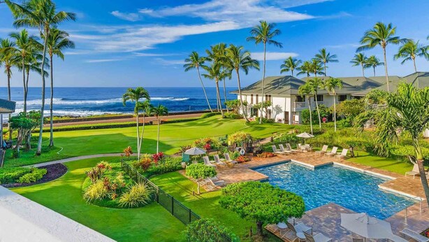 A resort with a pool, palm trees, and a view of the ocean. - Poipu Kapili 43 By Parrish Kauai- penthouse with panoramic ocean views! (Koloa)