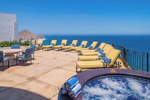 A rooftop terrace with sun loungers and a hot tub overlooking the ocean. - Oceanfront Luxury 12k SqFt Med-Style Villa w/ Pool, Hot Tub & Ocean Views Cabo (Cabo San Lucas)