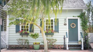 A house with a green door, a number plaque, and a wreath on the door.
