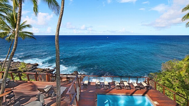 A deck with lounge chairs and a pool overlooking the ocean. - Poipu Palms #203 By Parrish Kauai: pristine, updated oceanfront gem w/ sunsets & (Koloa)