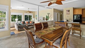 A spacious living area with a dining table, comfortable seating, and a kitchen area.
