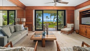 A modern living room with a sofa, chairs, a coffee table, and a TV. - Poipu Kapili 33 By Parrish Kauai - great for honeymoons! (Koloa)